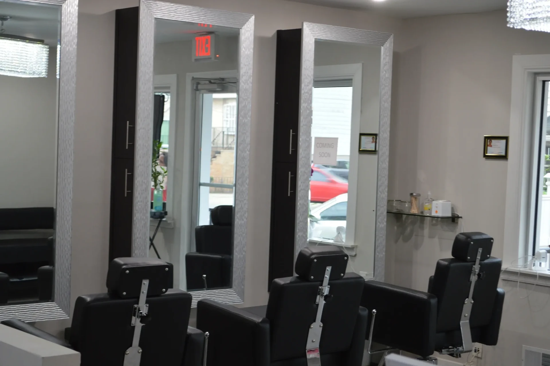 Styling stations with tall silver-framed mirrors and black salon chairs at Gargi's Beauty Clinic