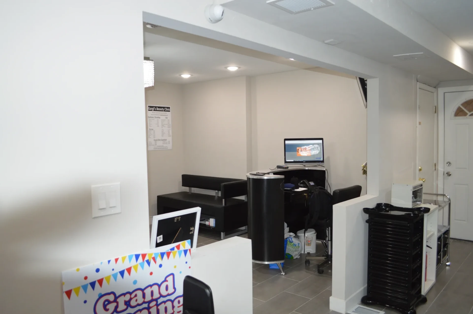 Reception desk and seating area with the service menu displayed on the wall